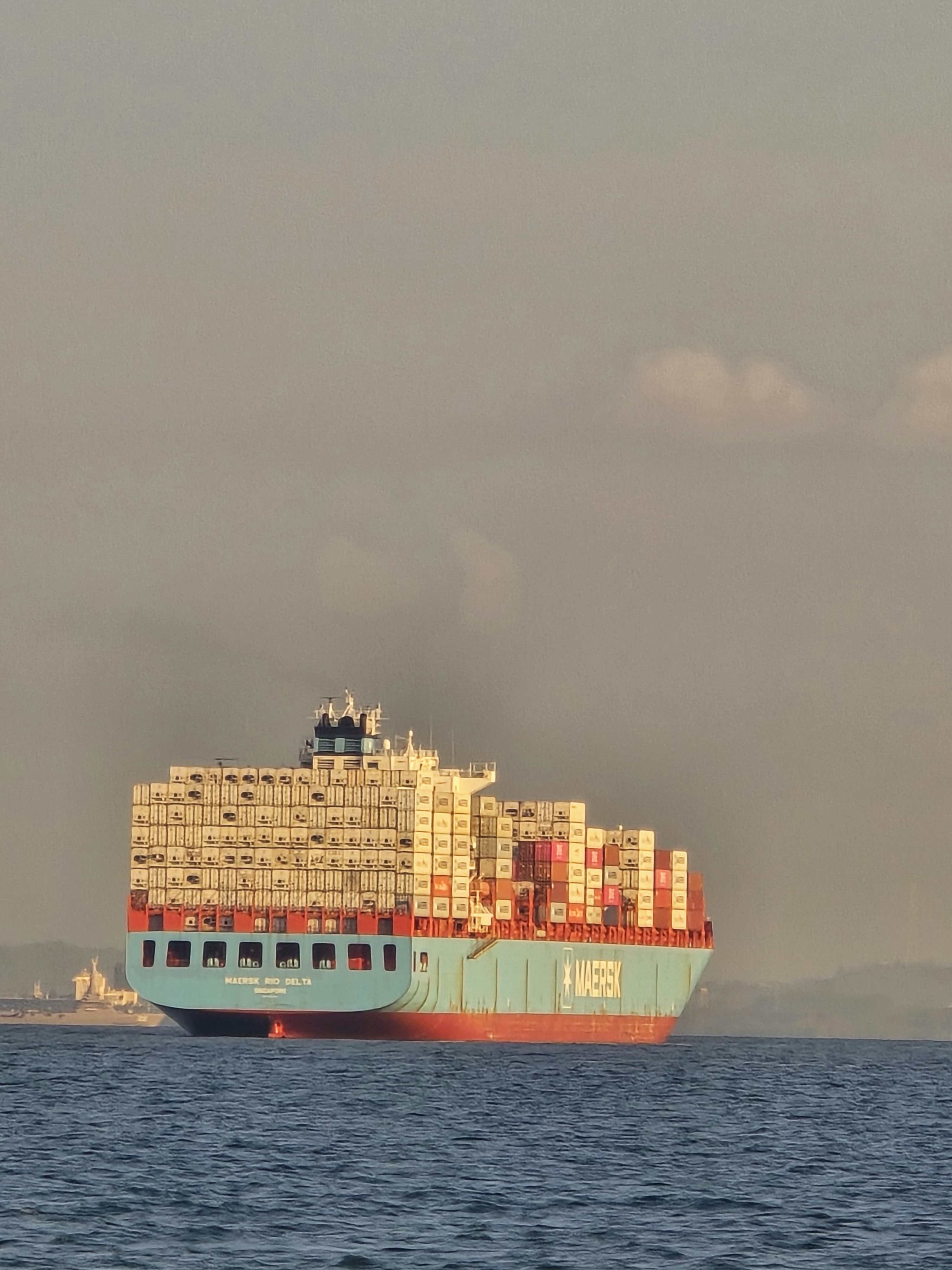A container ship at sea at dusk